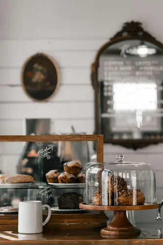 A cup and two vases with cakes